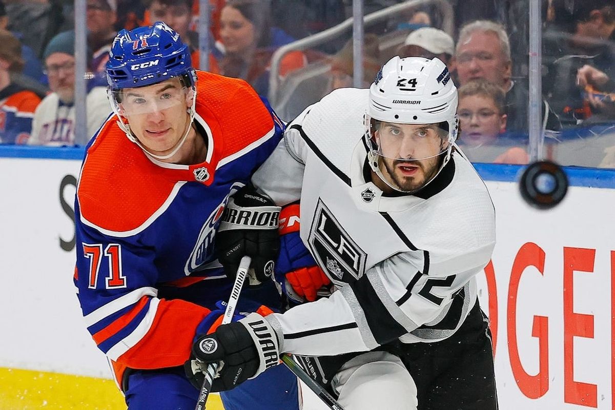Feb 26, 2024; Edmonton, Alberta, CAN; Edmonton Oilers forward Ryan McLeod (71) and Los Angeles Kings forward Phillip Danault (24) follow a loose puck during the second period at Rogers Place.