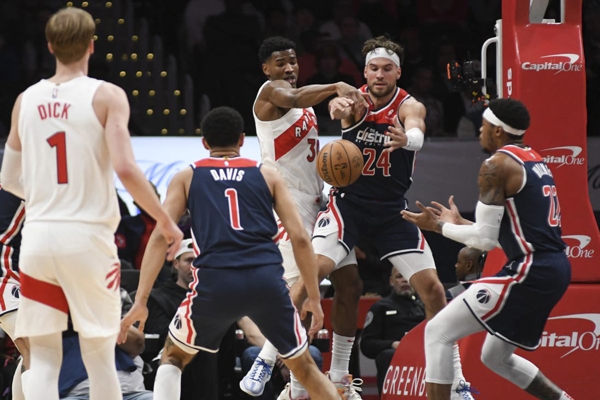 Mar 23, 2024; Washington, District of Columbia, USA;  Toronto Raptors guard Ochai Agbaji (30) and Washington Wizards forward Corey Kispert (24) leap for a loose ball during the first half at Capital One Arena.