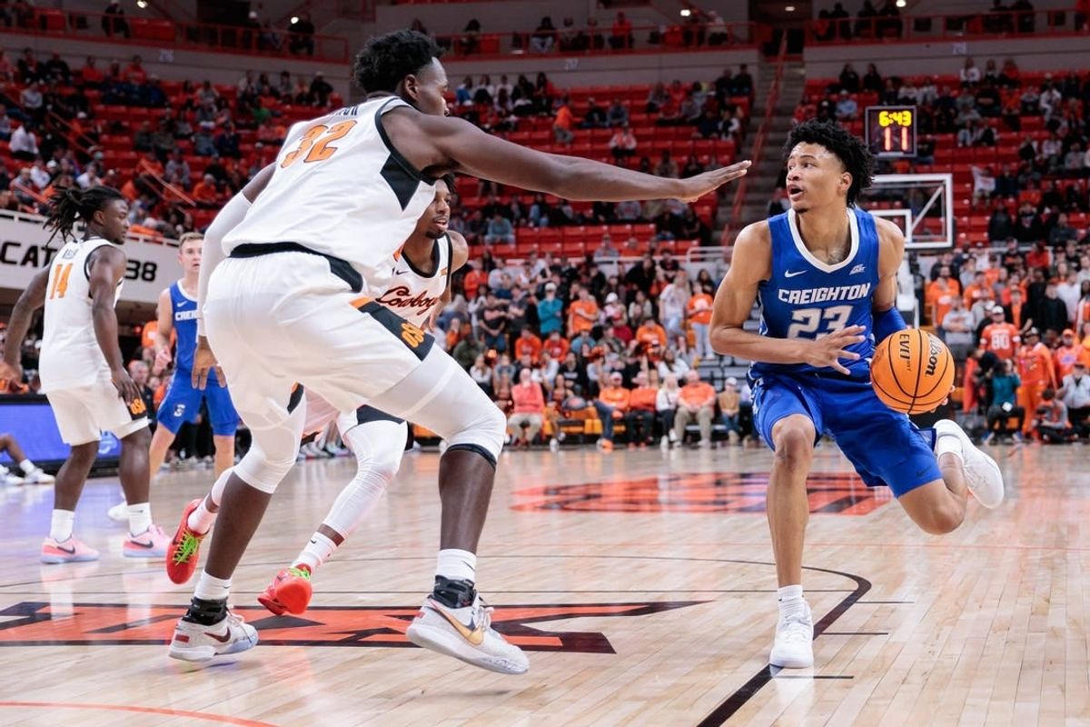 Nov 30, 2023; Stillwater, Oklahoma, USA; Creighton Bluejays guard Trey Alexander (23) drives to the basket around Oklahoma State Cowboys center Mike Marsh (32) during the second half at Gallagher-Iba Arena.