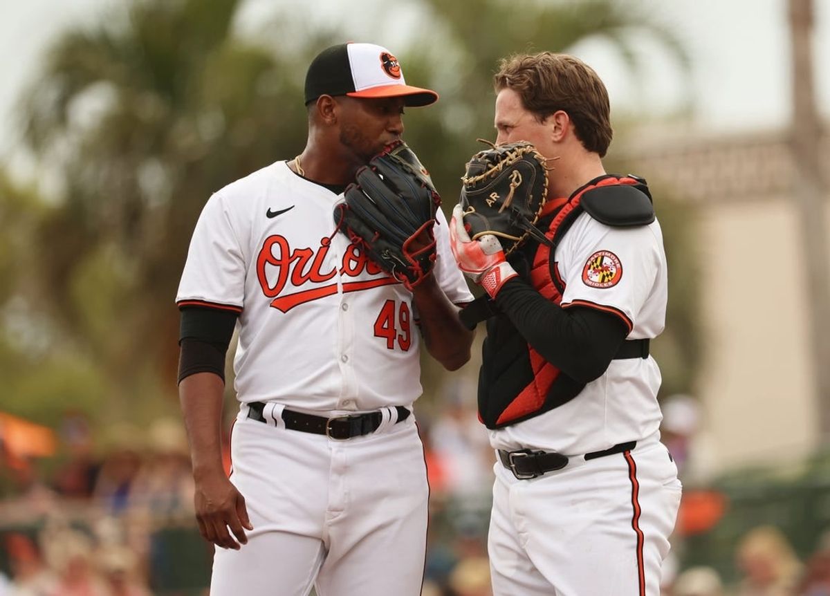Mar 2, 2024; Sarasota, Florida, USA; Baltimore Orioles pitcher Julio Teheran (49) talks with catcher Adley Rutschman (35) during the fourth inning against the New York Yankees at Ed Smith Stadium.