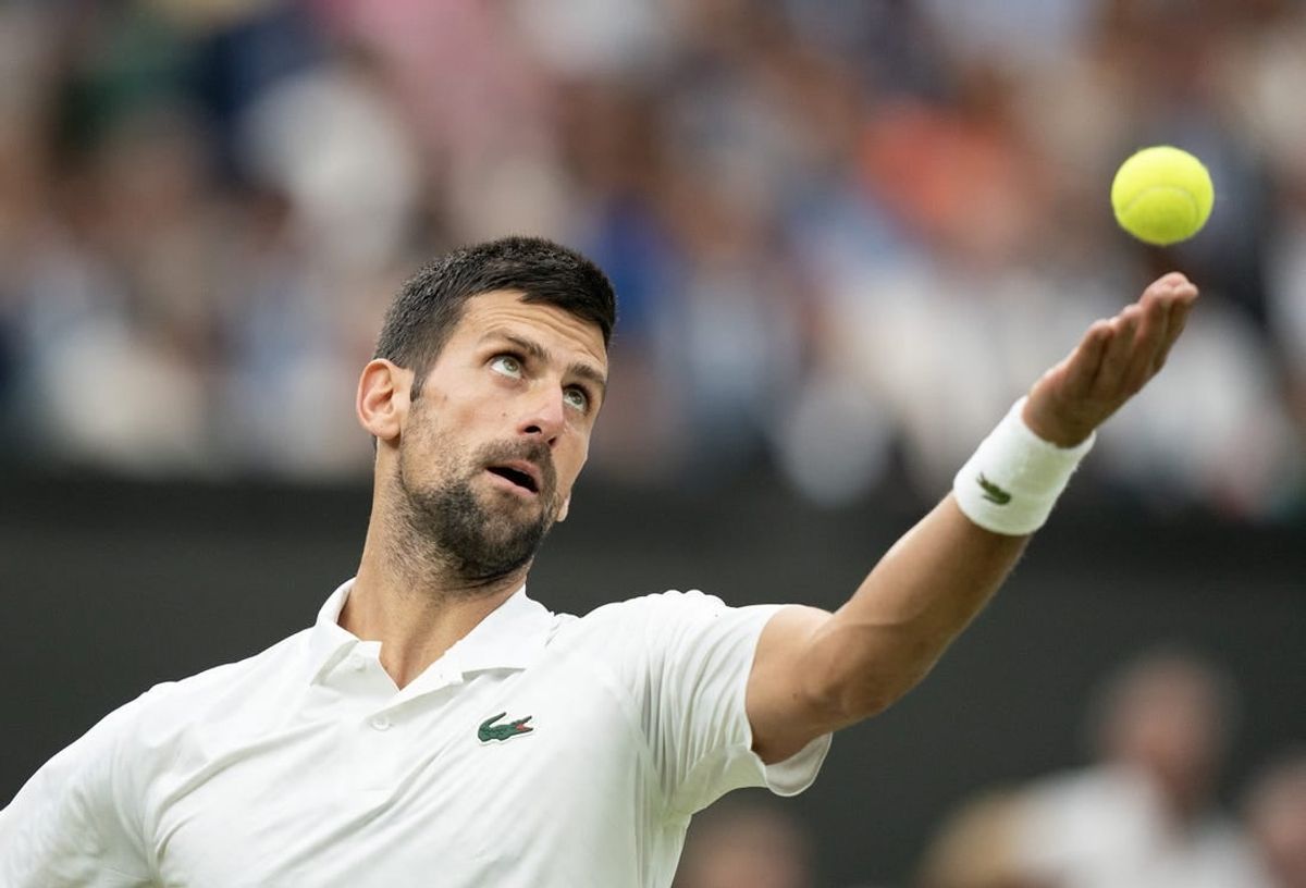 Jul 14, 2023; London, United Kingdom; Novak Djokovic (SRB) tosses the ball to serve during his match against Jannik Sinner (ITA) on day 12 at the All England Lawn Tennis and Croquet Club.
