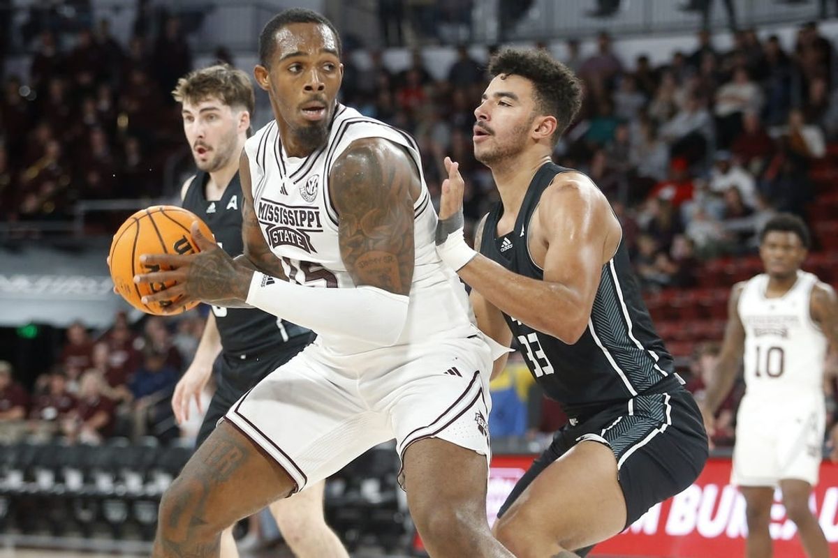 Nov 14, 2023; Starkville, Mississippi, USA; Mississippi State Bulldogs forward Jimmy Bell Jr. (15) spins toward the basket as North Alabama Lions forward Damian Forrest (33) defends during the first half at Humphrey Coliseum.