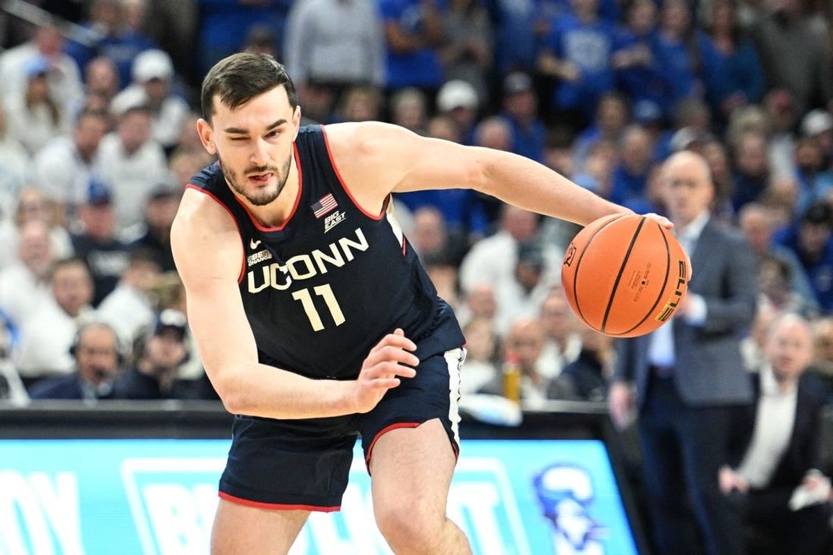 Feb 20, 2024; Omaha, Nebraska, USA;  Connecticut Huskies forward Alex Karaban (11) dribbles against the Creighton Bluejays in the first half at CHI Health Center Omaha.