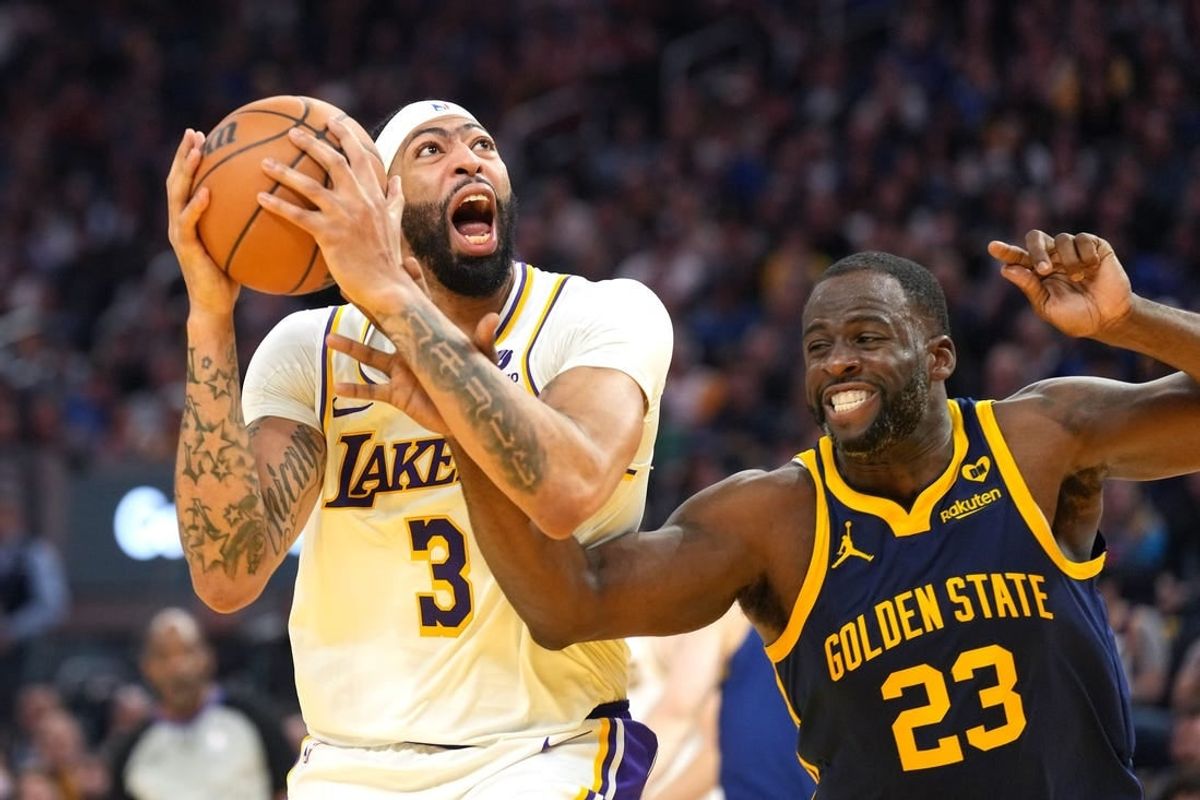 Jan 27, 2024; San Francisco, California, USA; Los Angeles Lakers forward Anthony Davis (3) shoots while being fouled by Golden State Warriors forward Draymond Green (23) during the second quarter at Chase Center.