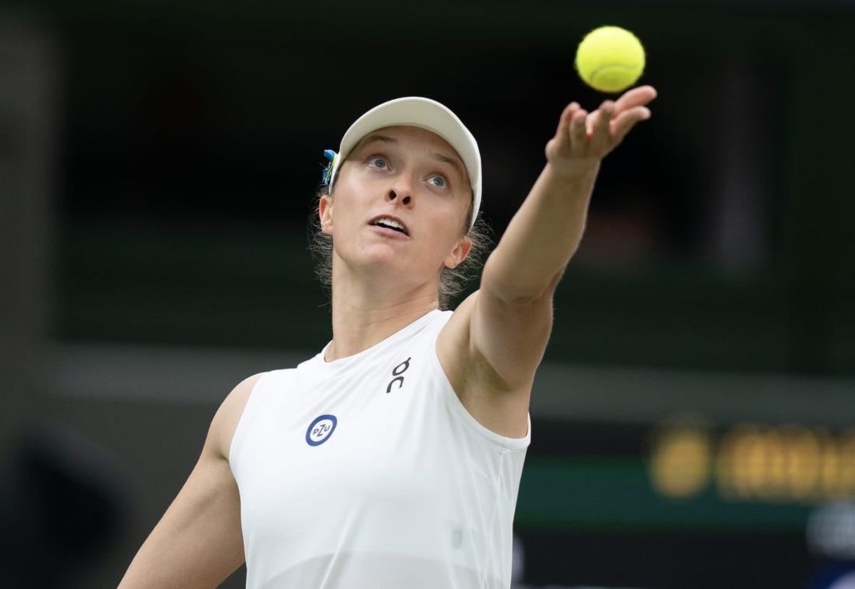 Jul 11, 2023; London, United Kingdom; Iga Swiatek (POL) tosses the ball to serve during her match against Elina Svitolina (UKR) on day nine of Wimbledon at the All England Lawn Tennis and Croquet Club.