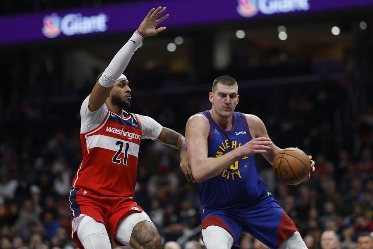 Jan 21, 2024; Washington, District of Columbia, USA; Denver Nuggets center Nikola Jokic (15) drives to the basket as Washington Wizards center Daniel Gafford (21) defends in the first half at Capital One Arena.