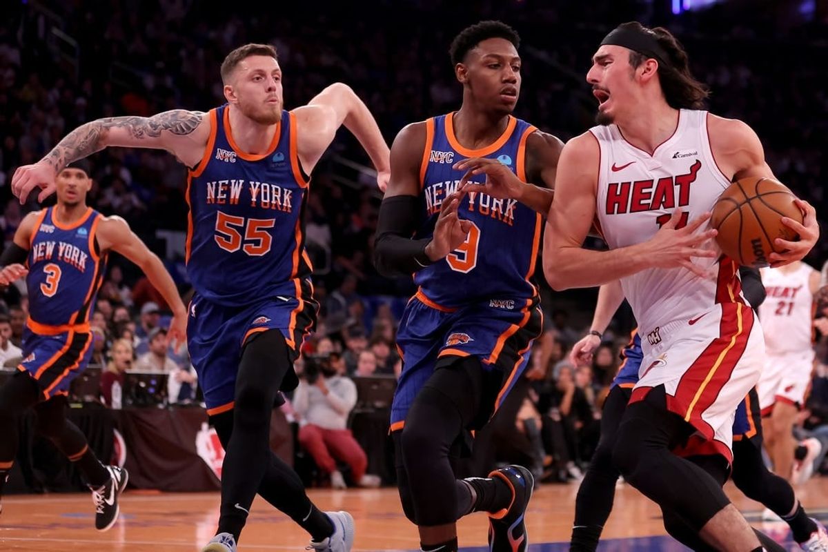 Nov 24, 2023; New York, New York, USA; Miami Heat guard Jaime Jaquez Jr. (11) drives to the basket against New York Knicks guard RJ Barrett (9) and center Isaiah Hartenstein (55) during the second quarter at Madison Square Garden.