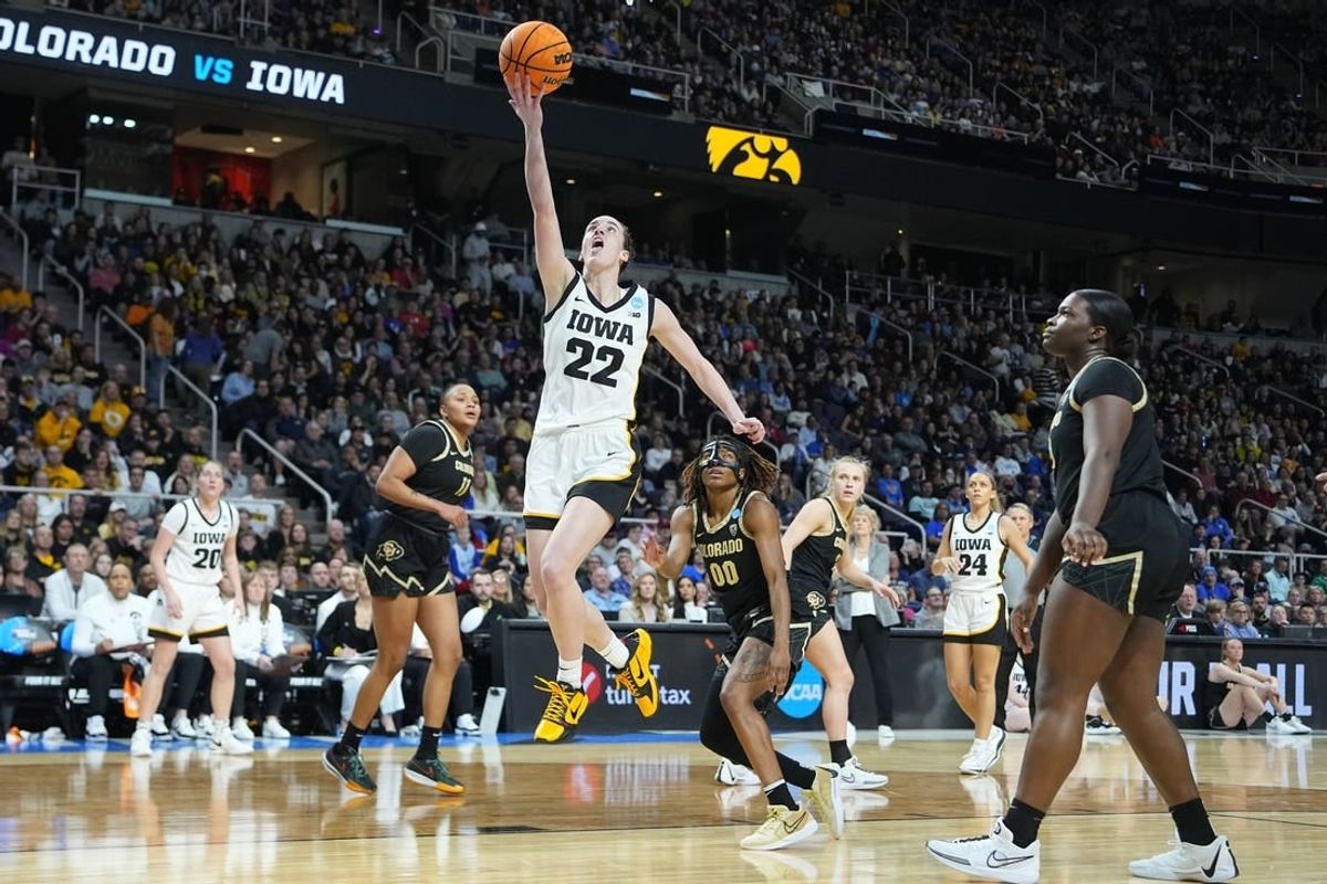 Mar 30, 2024; Albany, NY, USA;  Iowa Hawkeyes guard Caitlin Clark (22) shoots the ball past Colorado Buffaloes guard Jaylyn Sherrod (0) during the second half in the semifinals of the Albany Regional of the 2024 NCAA Tournament at MVP Arena.