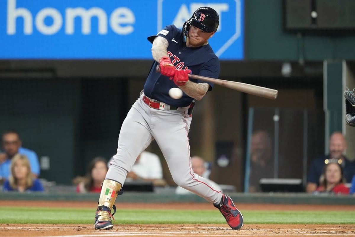 Sep 20, 2023; Arlington, Texas, USA; Boston Red Sox right fielder Alex Verdugo (99) hits a single against the Texas Rangers during the first inning at Globe Life Field.