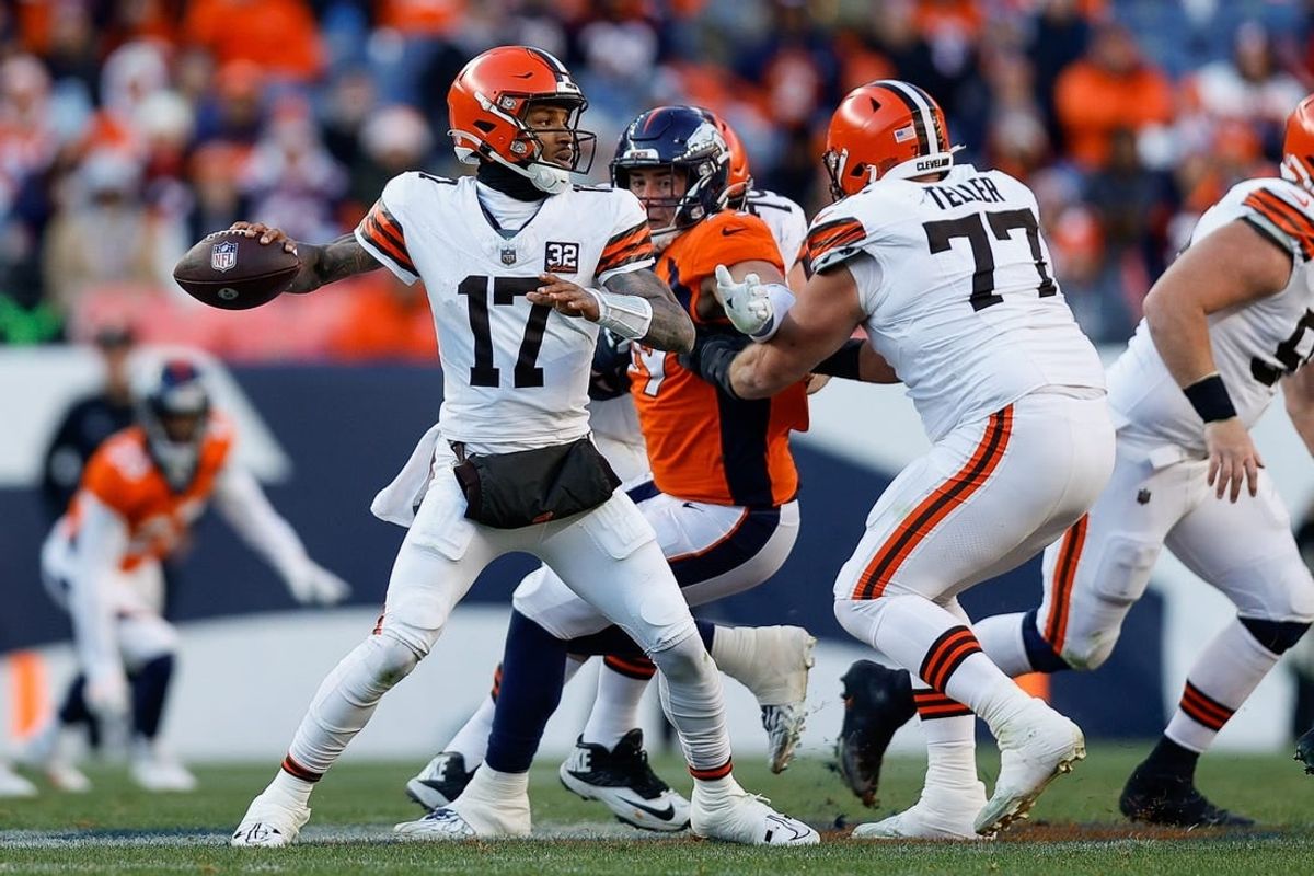 Nov 26, 2023; Denver, Colorado, USA; Cleveland Browns quarterback Dorian Thompson-Robinson (17) looks to pass as guard Wyatt Teller (77) defends against Denver Broncos defensive end Zach Allen (99) in the second quarter at Empower Field at Mile High.