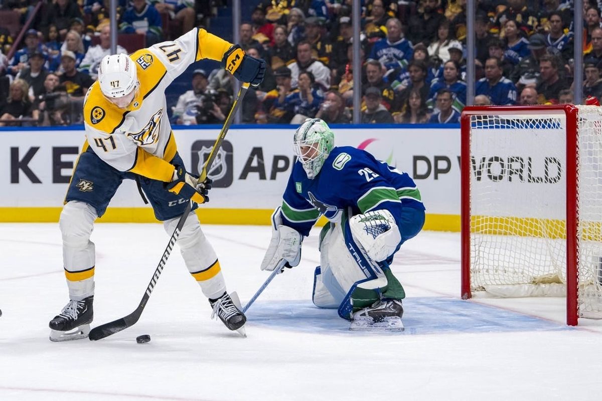 Apr 23, 2024; Vancouver, British Columbia, CAN; Vancouver Canucks goalie Casey DeSmith (29) watches Nashville Predators forward Michael McCarron (47) handle the puck during the second period in game two of the first round of the 2024 Stanley Cup Playoffs at Rogers Arena.