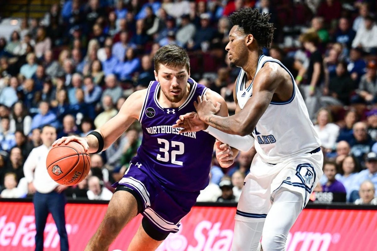 Nov 18, 2023; Uncasville, Connecticut, USA; Northwestern Wildcats forward Blake Preston (32) dribbles the ball defended by Rhode Island Rams guard Luis Kortright (1) during the second half at Mohegan Sun Arena.