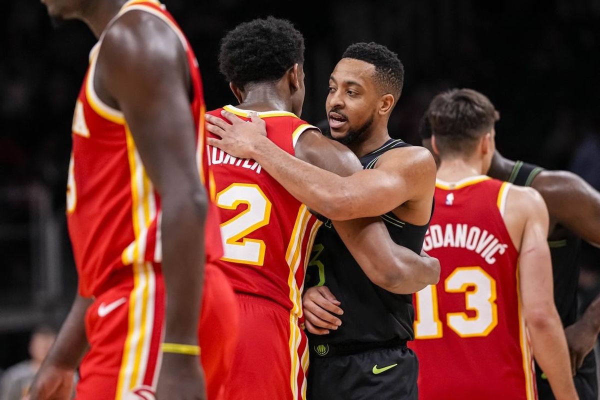 Mar 10, 2024; Atlanta, Georgia, USA; Atlanta Hawks forward De'Andre Hunter (12) and New Orleans Pelicans guard CJ McCollum (3) react together after the game at State Farm Arena.