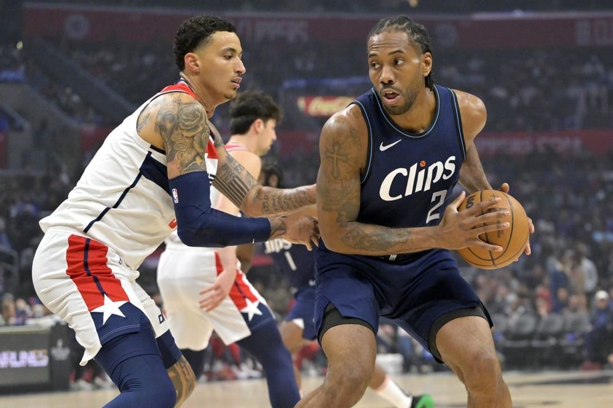 Mar 1, 2024; Los Angeles, California, USA; Los Angeles Clippers forward Kawhi Leonard (2) is defended by Washington Wizards forward Kyle Kuzma (33) in the first half at Crypto.com Arena.