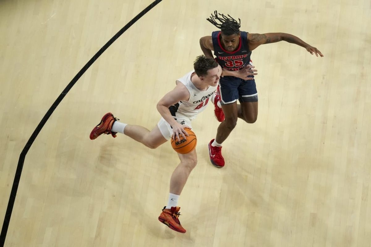 Nov 10, 2023; Cincinnati, Ohio, USA;  Cincinnati Bearcats guard Simas Lukosius (41) drives to the basket against Detroit Mercy Titans guard Marcus Tankersley (35) in the first half at Fifth Third Arena.