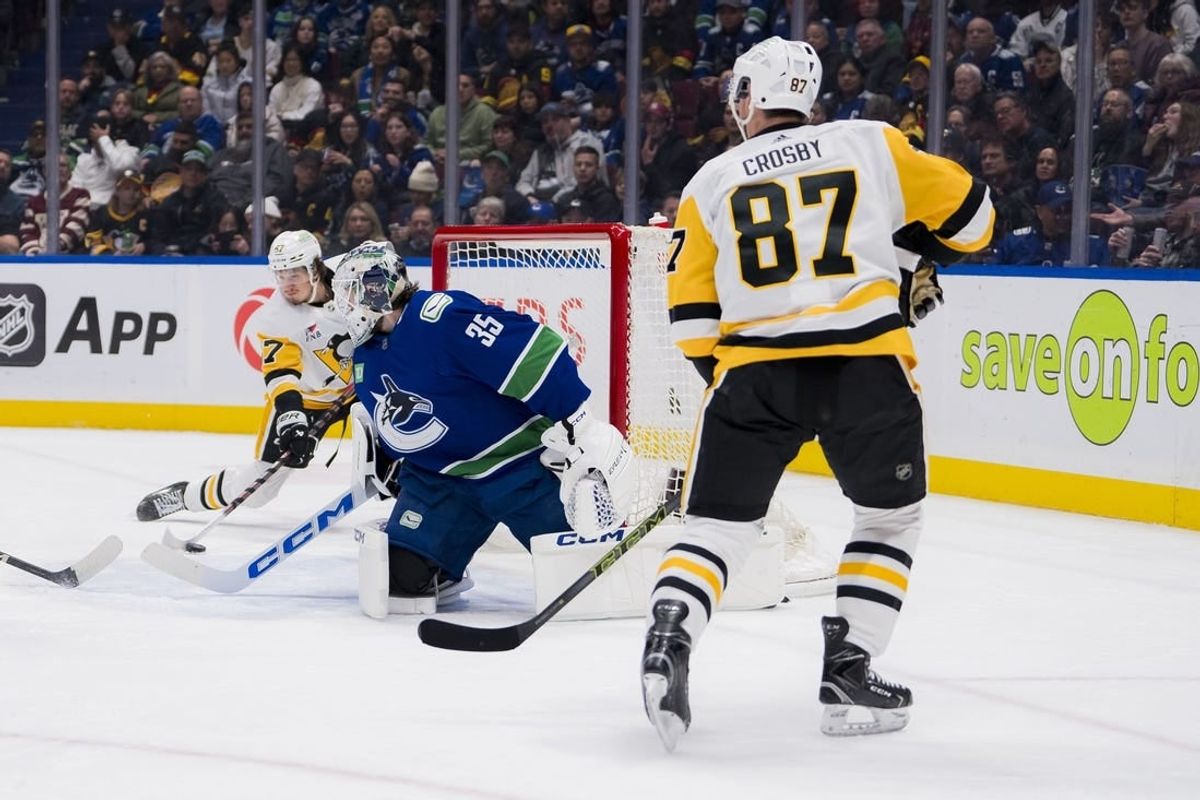 Feb 27, 2024; Vancouver, British Columbia, CAN; Pittsburgh Penguins forward Sidney Crosby (87) watches as forward Rickard Rakell (67) scores on Vancouver Canucks goalie Thatcher Demko (35) in the second period at Rogers Arena.