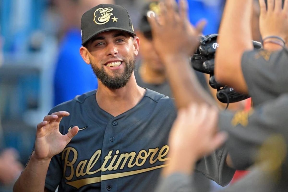 Jul 19, 2022; Los Angeles, California, USA; American League relief pitcher Jorge Lopez (48) of the Baltimore Orioles smiles as he gets high fives in the dugout after pitching against the National League during the seventh inning of the 2022 MLB All Star Game at Dodger Stadium.