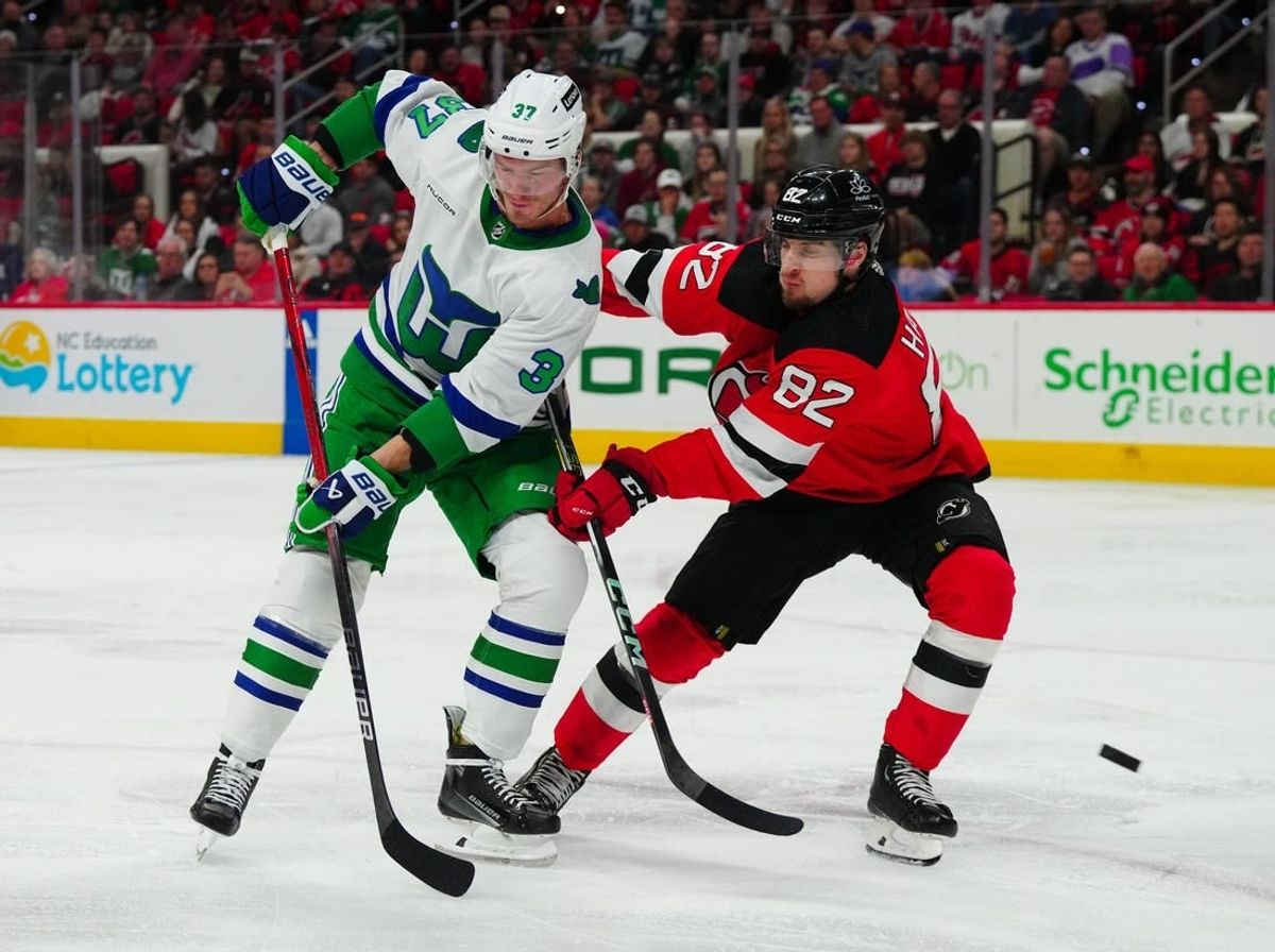 Feb 10, 2024; Raleigh, North Carolina, USA; Carolina Hurricanes right wing Andrei Svechnikov (37) and New Jersey Devils defenseman Santeri Hatakka (82) watch the shot during the second period at PNC Arena.