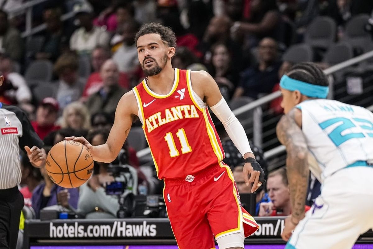 Apr 10, 2024; Atlanta, Georgia, USA; Atlanta Hawks guard Trae Young (11) controls the ball against the Charlotte Hornets during the first half at State Farm Arena.
