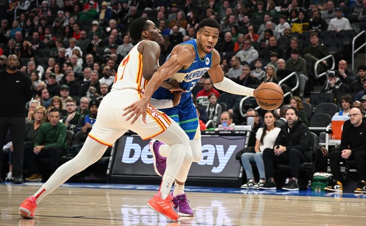 Dec 2, 2023; Milwaukee, Wisconsin, USA; Milwaukee Bucks forward Giannis Antetokounmpo (34) drives the baseline against Atlanta Hawks forward Onyeka Okongwu (17) in the first half at Fiserv Forum.