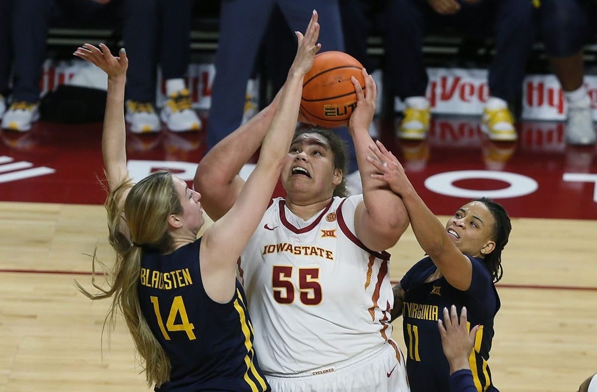 Iowa State Cyclones center Audi Crooks (55) takes a shot between West Virginia Mountaineers forward Kylee Blacksten (14) and guard JJ Quinerly (11) during the second quarter in the Big-12 conference matchup at Hilton Coliseum on Wednesday, Jan. 10, 2024, in Ames, Iowa.