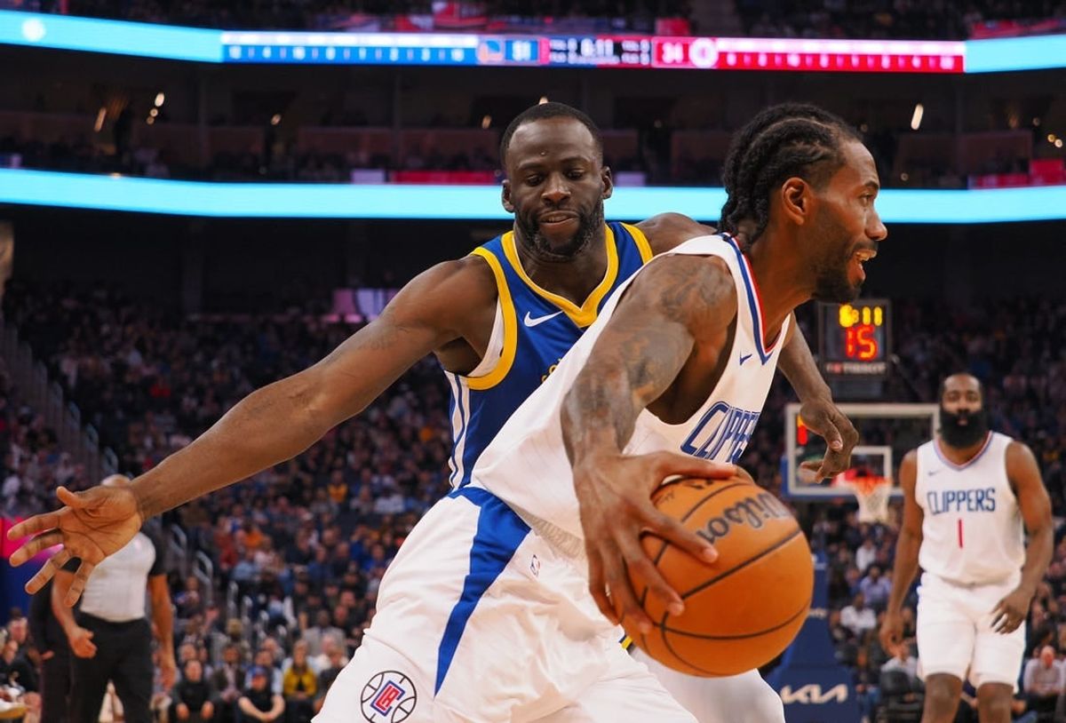Nov 30, 2023; San Francisco, California, USA; Los Angeles Clippers forward Kawhi Leonard (2) controls the ball against Golden State Warriors forward Draymond Green (23) during the second quarter at Chase Center.