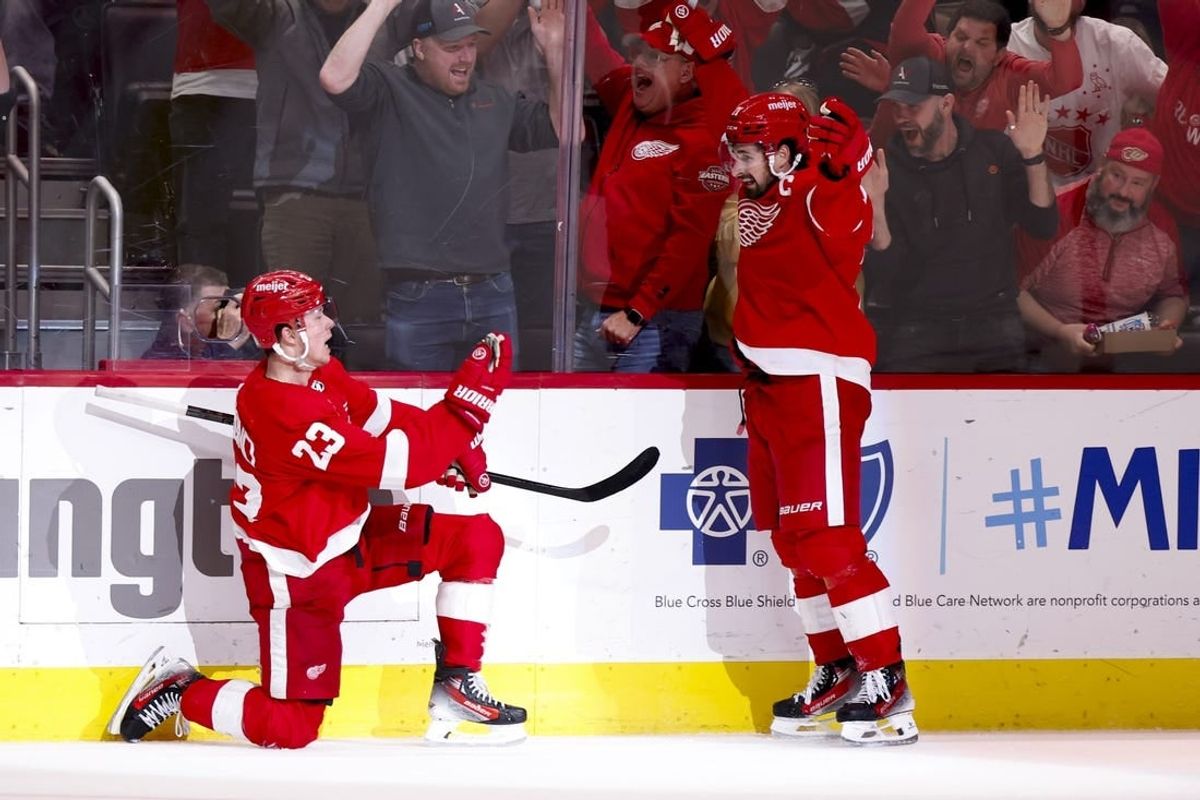Apr 15, 2024; Detroit, Michigan, USA;  Detroit Red Wings left wing Lucas Raymond (23) celebrates with center Dylan Larkin (71) after he scores in overtime against the Montreal Canadiens at Little Caesars Arena.