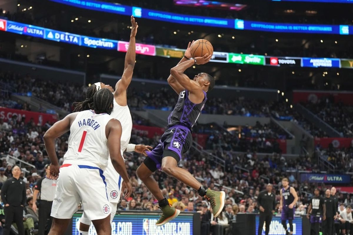Feb 25, 2024; Los Angeles, California, USA; Sacramento Kings guard De'Aaron Fox (5) shoots the ball against LA Clippers guard Terance Mann (14) in the second half at Crypto.com Arena.