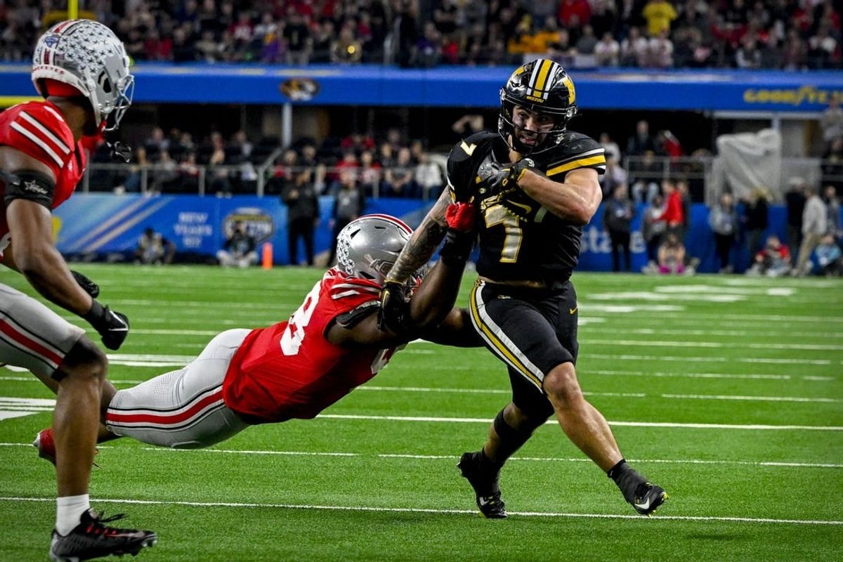 Dec 29, 2023; Arlington, TX, USA; Missouri Tigers running back Cody Schrader (7) runs for a first down against the Ohio State Buckeyes during the fourth quarter at AT&T Stadium.