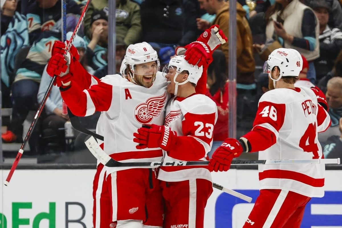 Feb 19, 2024; Seattle, Washington, USA; Seattle Kraken left wing Jared McCann (19) celebrates  with left wing Lucas Raymond (23) after scoring a goal against the Detroit Red Wings during the second period at Climate Pledge Arena.