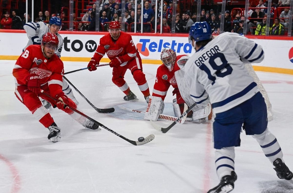 Nov 17, 2023; Stockholm, SWE; Detroit Red Wings center Andrew Copp (18) and Detroit Red Wings goaltender Alex Lyon (34) defend a shot by Toronto Maple Leafs center Noah Gregor (18) during a Global Series NHL hockey game at Avicii Arena.