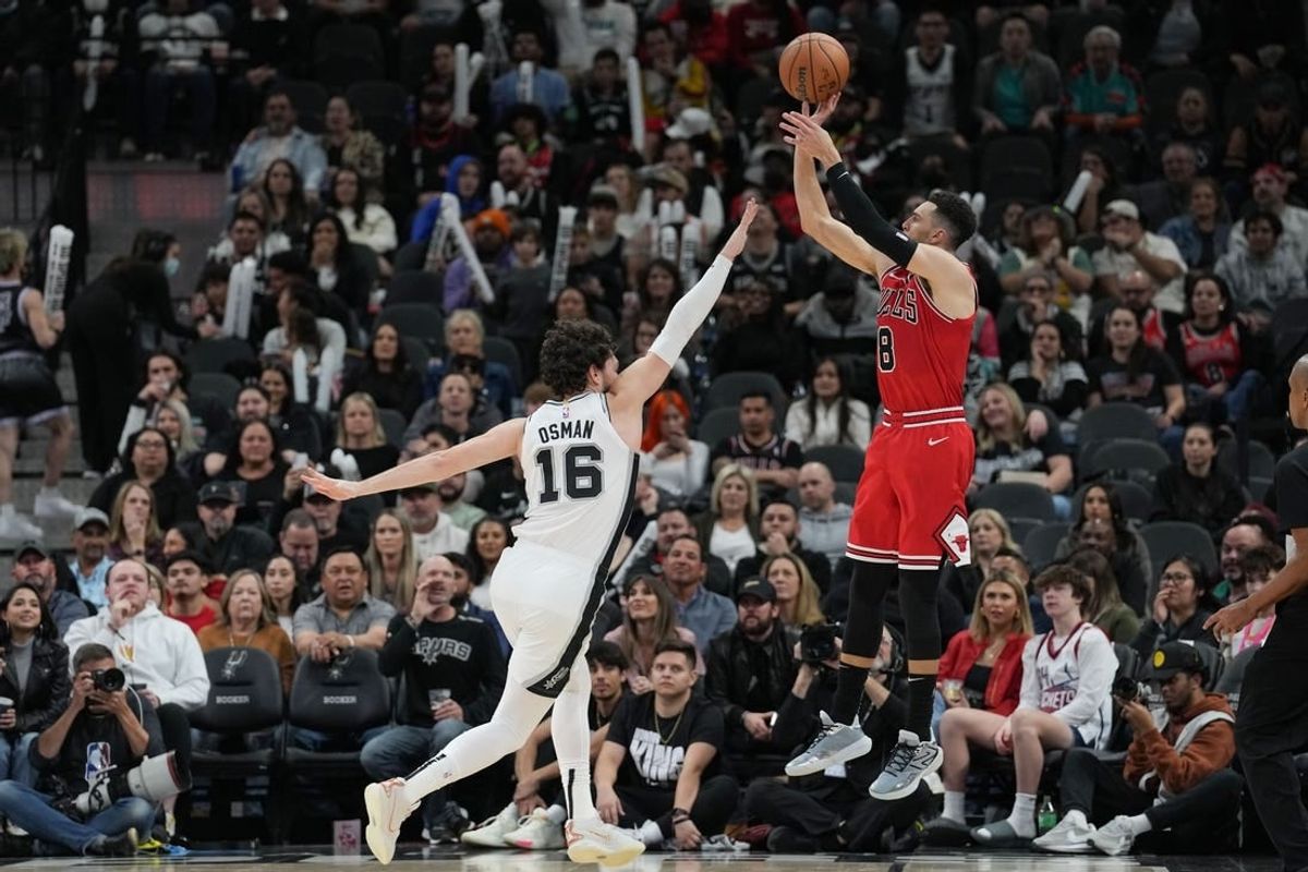 Jan 13, 2024; San Antonio, Texas, USA;  Chicago Bulls guard Zach LaVine (8) shoots over San Antonio Spurs forward Cedi Osman (16) in the second half at Frost Bank Center.