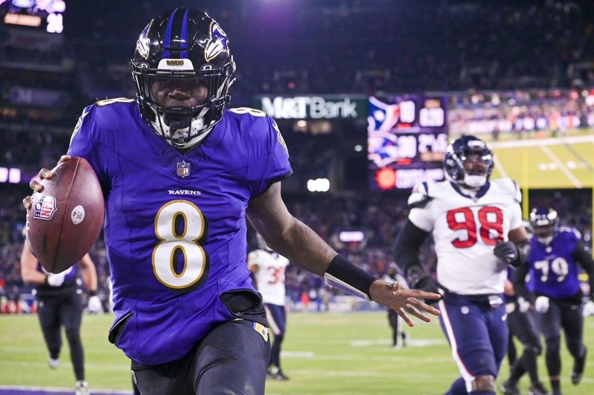 Jan 20, 2024; Baltimore, MD, USA; Baltimore Ravens quarterback Lamar Jackson (8) reacts after running past for Houston Texans defensive tackle Sheldon Rankins (98) for a touchdown during the fourth quarter  in a 2024 AFC divisional round game at M&T Bank Stadium.