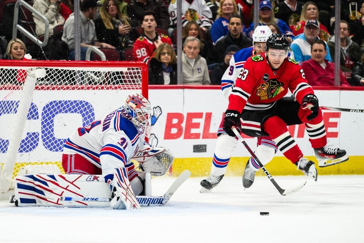 Feb 9, 2024; Chicago, Illinois, USA; Chicago Blackhawks center Philipp Kurashev (23) jumps off the ice as New York Rangers goaltender Igor Shesterkin (31) defends his goal during the first period at the United Center.