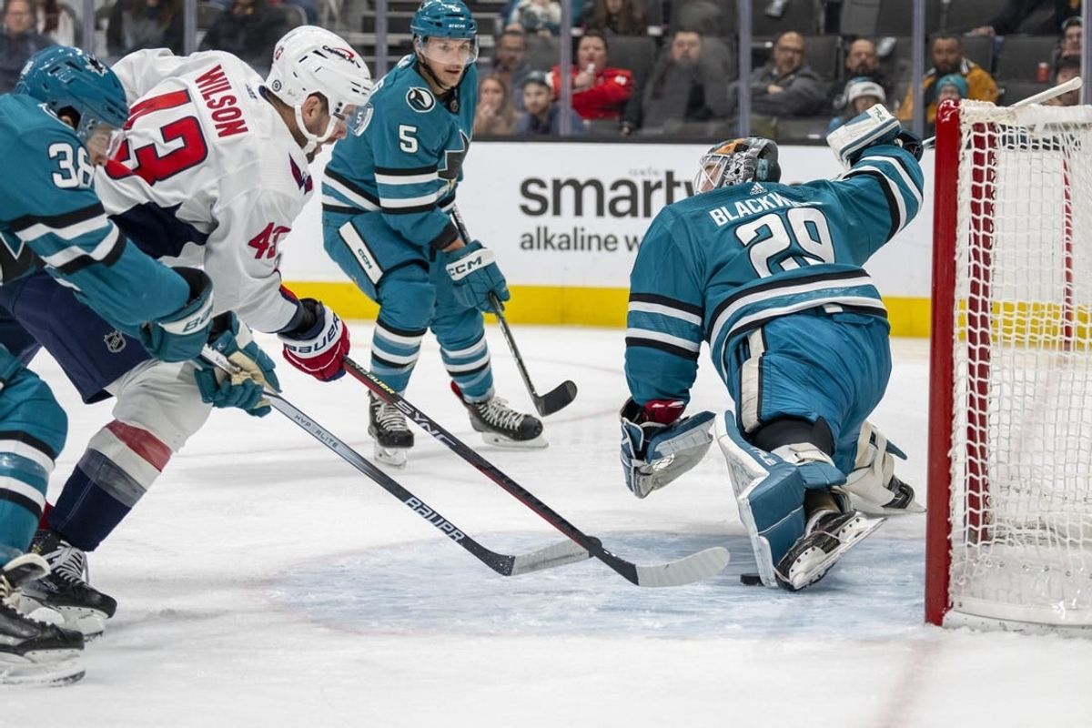 Nov 27, 2023; San Jose, California, USA; San Jose Sharks goaltender Mackenzie Blackwood (29) makes a leg save against Washington Capitals right wing Tom Wilson (43) during the first period at SAP Center at San Jose.