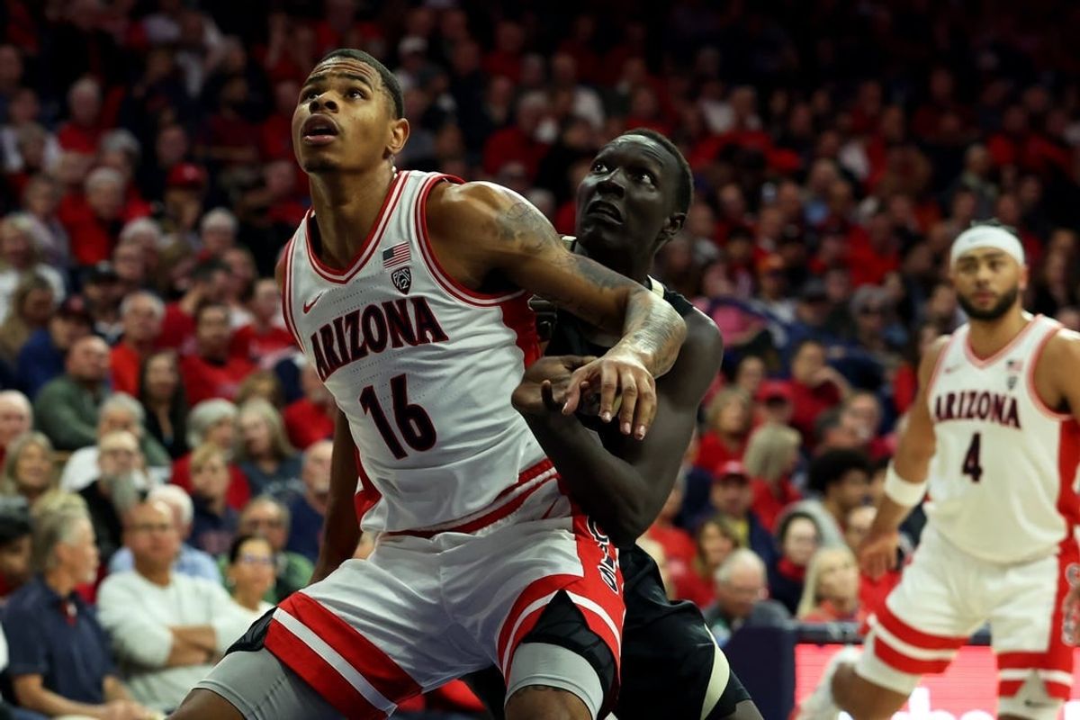 Jan 4, 2024; Tucson, Arizona, USA; Arizona Wildcats forward Keshad Johnson (16) and Colorado Buffaloes forward Bangot Dak (12) go for a rebound during the first half at McKale Center.
