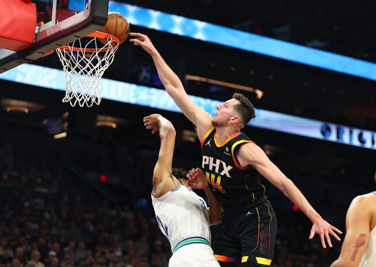 Nov 15, 2023; Phoenix, Arizona, USA; Phoenix Suns forward Drew Eubanks (right) slam dunks the ball against Minnesota Timberwolves center Karl-Anthony Towns in the first half at Footprint Center.