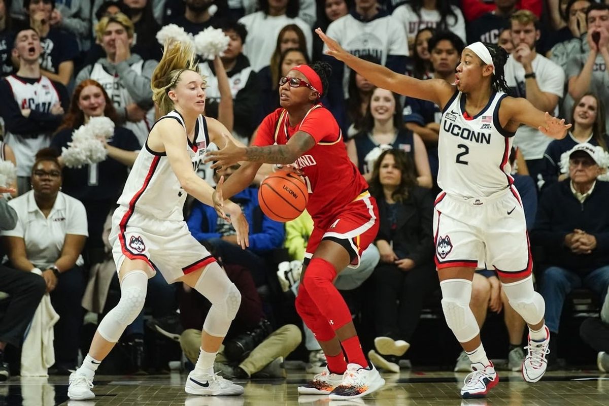 Nov 16, 2023; Storrs, Connecticut, USA; Connecticut Huskies guard Paige Bueckers (5) and Maryland Terrapins guard Jakia Brown-Turner (11) battle for a loose ball during the second half at Harry A. Gampel Pavilion.