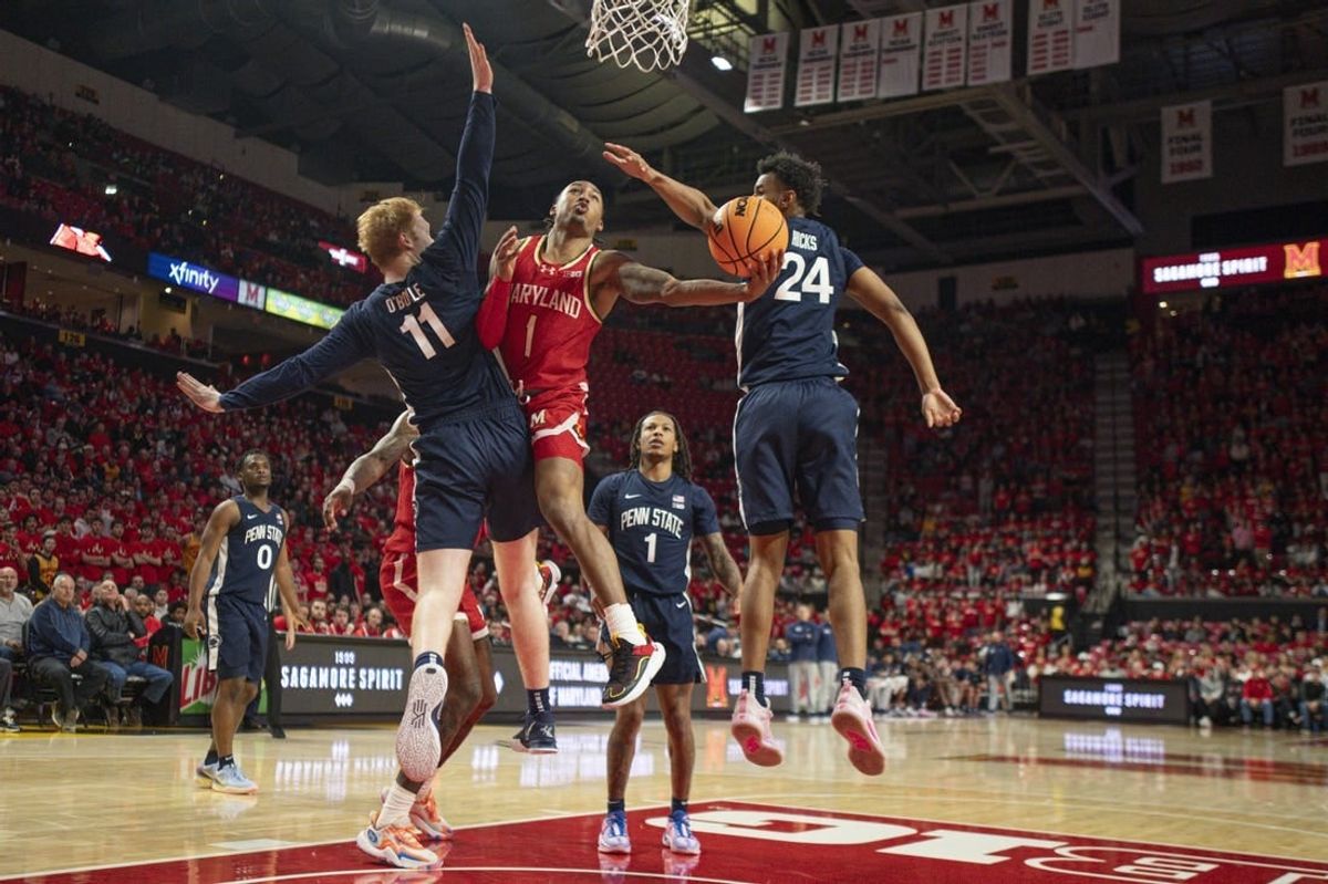 Dec 6, 2023; College Park, Maryland, USA;  Maryland Terrapins guard Jahmir Young (1) shoots around Penn State Nittany Lions forward Leo O'Boyle (11) during the second half at Xfinity Center.