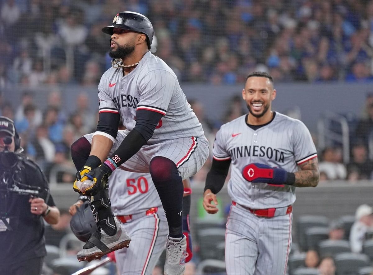 May 11, 2024; Toronto, Ontario, CAN; Minnesota Twins first base Carlos Santana (30) catches a sausage thrown out from the dugout after hitting a three run home run against the Toronto Blue Jays during the third inning at Rogers Centre.