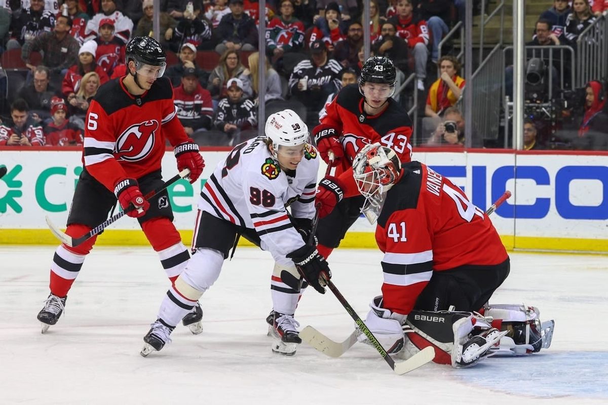 Jan 5, 2024; Newark, New Jersey, USA; New Jersey Devils goaltender Vitek Vanecek (41) makes a save while Chicago Blackhawks center Connor Bedard (98) looks for the rebound during the first period at Prudential Center.