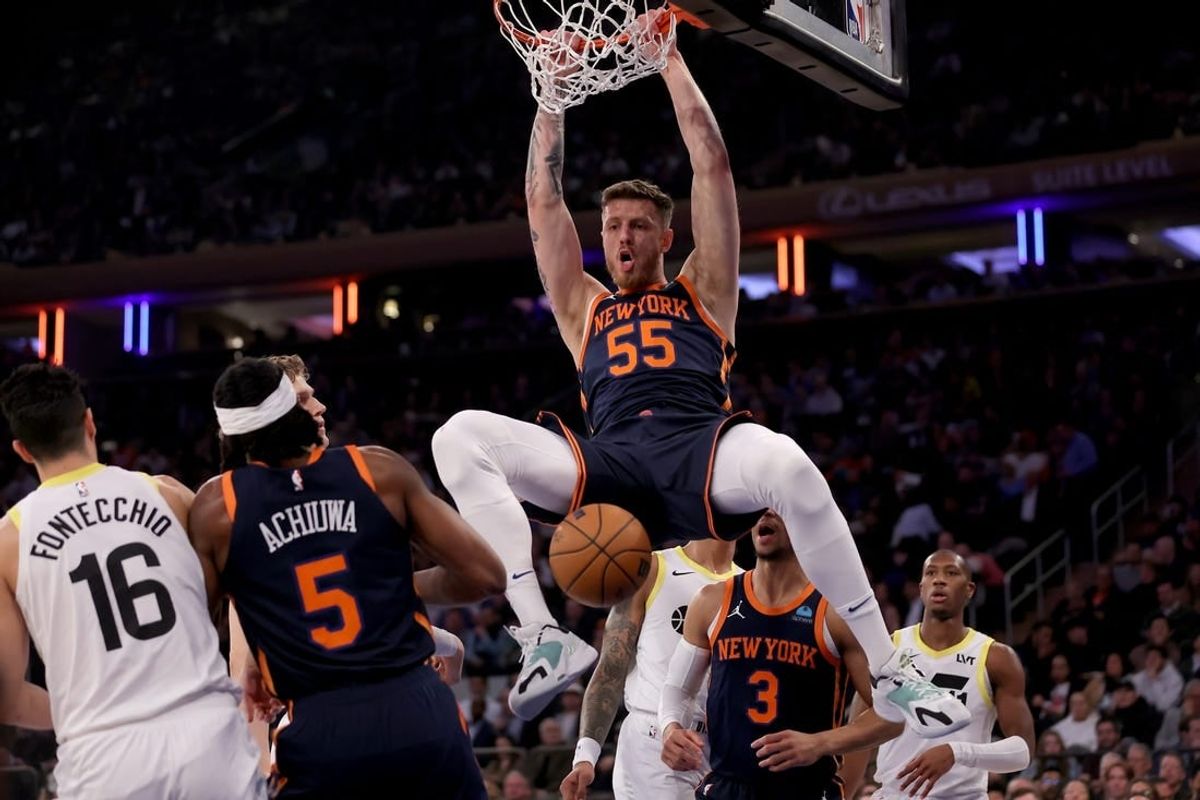 Jan 30, 2024; New York, New York, USA; New York Knicks center Isaiah Hartenstein (55) dunks against Utah Jazz forwards Simone Fontecchio (16) and Lauri Markkanen (23) and John Collins (20) and guard Kris Dunn (11) during the first quarter at Madison Square Garden.
