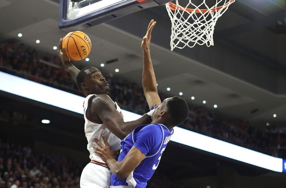 Feb 17, 2024; Auburn, Alabama, USA; Auburn Tigers forward Jaylin Williams (2) goes up against Kentucky Wildcats forward Ugonna Onyenso (33) for a shot during the second half at Neville Arena.