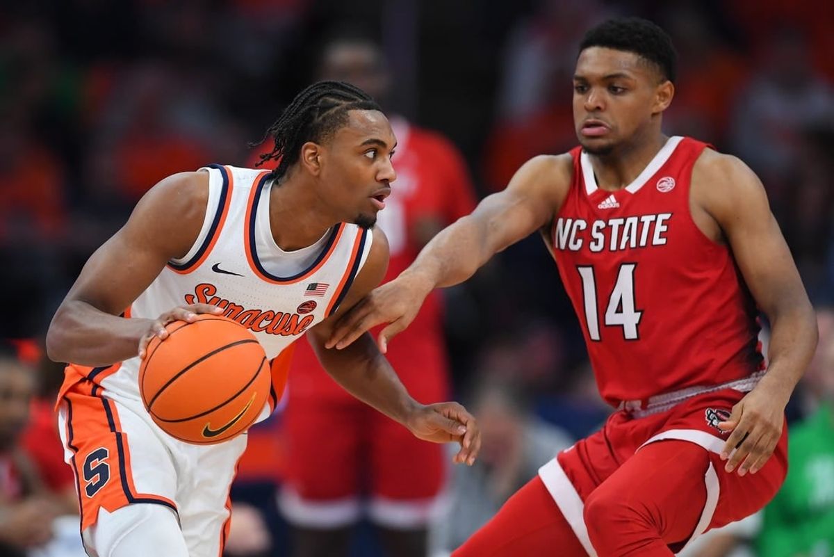 Jan 27, 2024; Syracuse, New York, USA; Syracuse Orange guard JJ Starling (2) drives to the basket as North Carolina State Wolfpack guard Casey Morsell (14) defends during the first half at the JMA Wireless Dome.