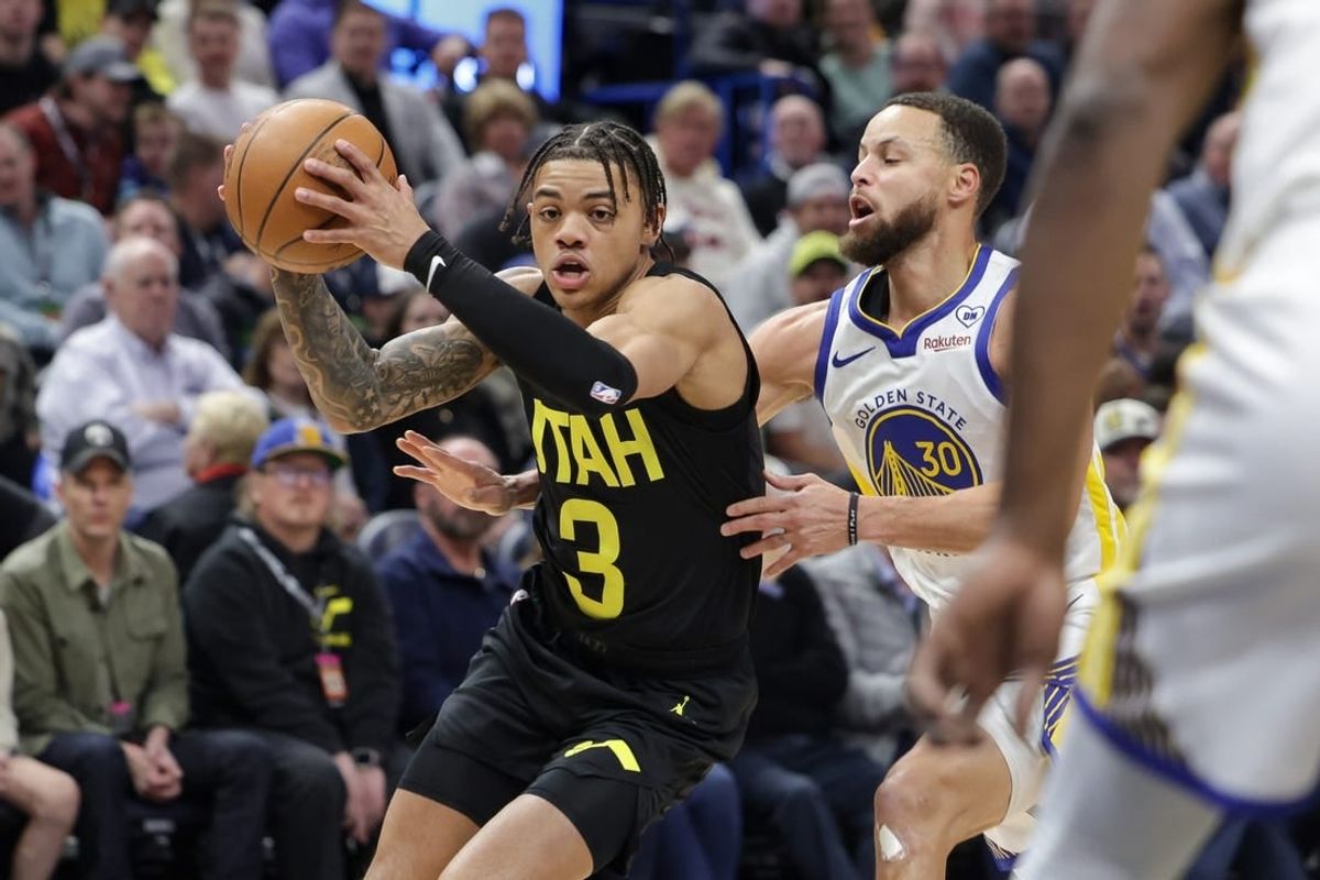 Feb 12, 2024; Salt Lake City, Utah, USA;  Utah Jazz guard Keyonte George (3) tries to get away from Golden State Warriors guard Stephen Curry (30) during the first quarter at Delta Center.