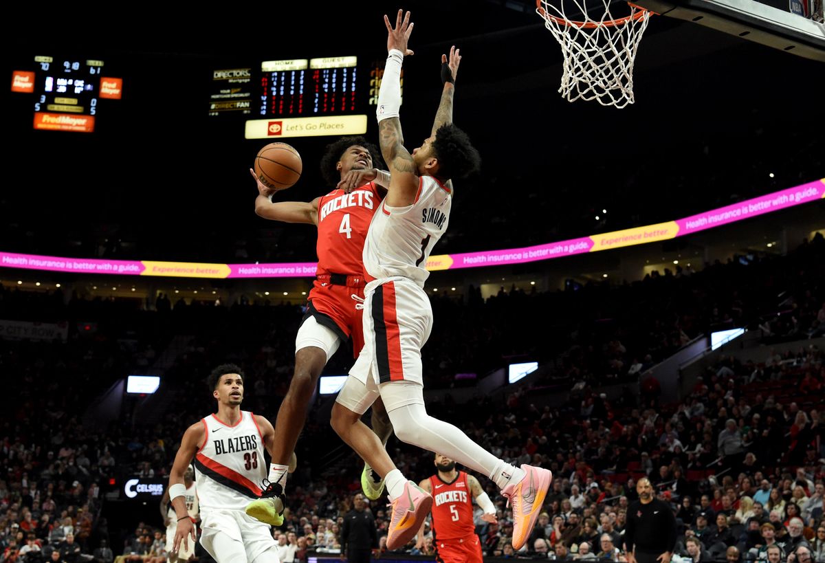 Houston Rockets guard Jalen Green (4) goes up for a dunk against Portland Trail Blazers guard Anfernee Simons, right, during the second half of an NBA basketball game in Portland, Ore., Friday, March 8, 2024.