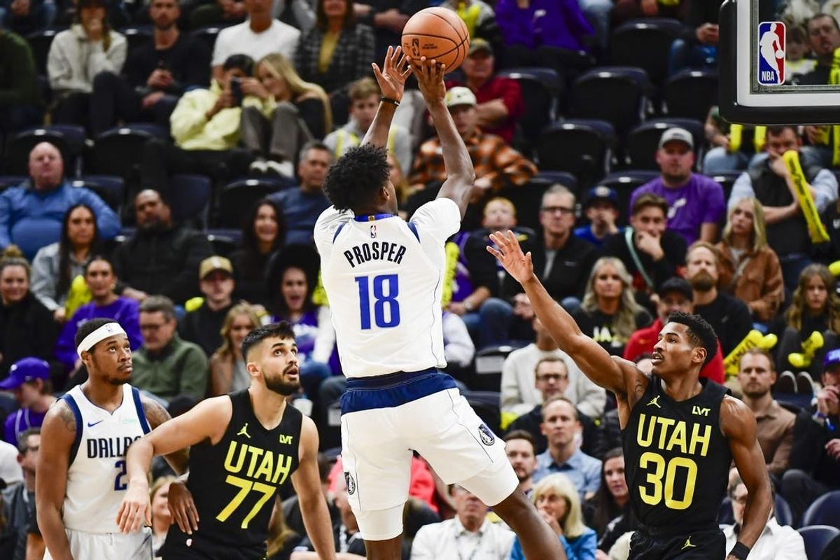 Jan 1, 2024; Salt Lake City, Utah, USA; Dallas Mavericks forward Olivier-Maxence Prosper (18) shoots over Utah Jazz guard Ochai Agbaji (30) during the second half at the Delta Center.
