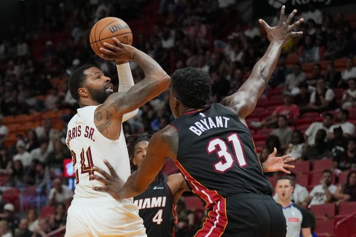 Mar 24, 2024; Miami, Florida, USA;  Cleveland Cavaliers forward Marcus Morris Sr. (24) takes a shot over Miami Heat center Thomas Bryant (31) during the second half at Kaseya Center.