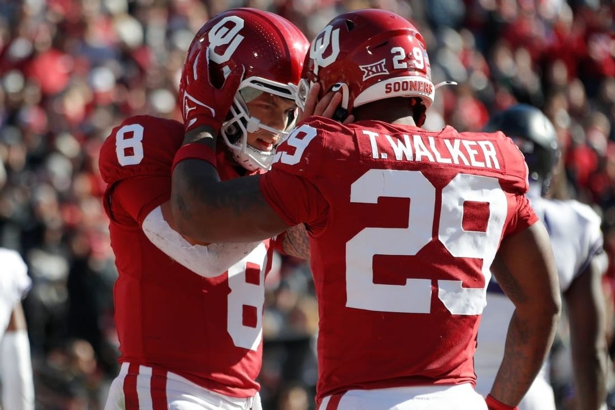 Nov 24, 2023; Norman, Oklahoma, USA; Oklahoma Sooners quarterback Dillon Gabriel (8) celebrates with running back Gavin Sawchuk (27) after a touchdown during the game against the TCU Horned Frogs  at Gaylord Family-Oklahoma Memorial Stadium.
