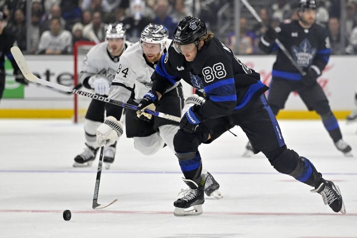 Jan 2, 2024; Los Angeles, California, USA; Toronto Maple Leafs right wing William Nylander (88) skates the puck past Los Angeles Kings defenseman Vladislav Gavrikov (84) in the first period at Crypto.com Arena.